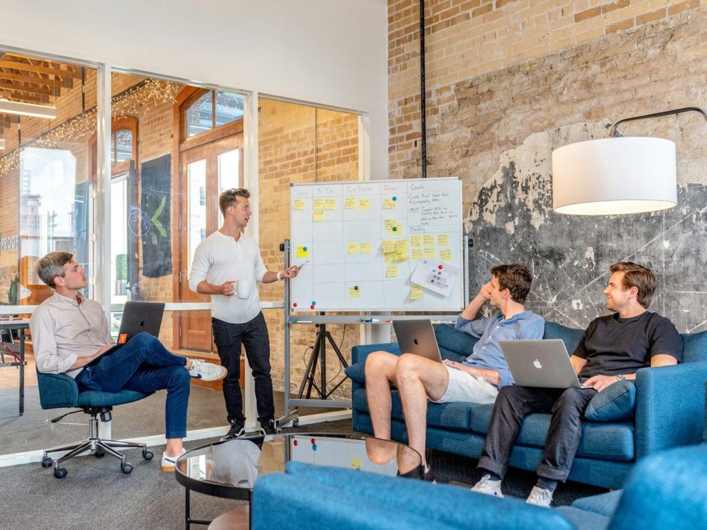 A team meeting round a whiteboard